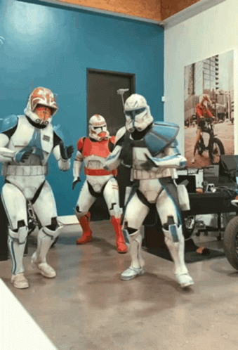 Three Stormtroopers Dancing In Room With Blue Wall GIF
