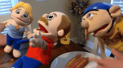 Three Stuffed Animals Are Sitting At A Table With A Plate Of Hot Dogs In Front Of Them GIF