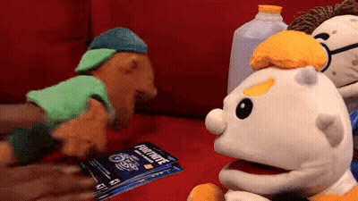 Three Stuffed Animals On Red Couch Holding Fortnite Gift Card GIF