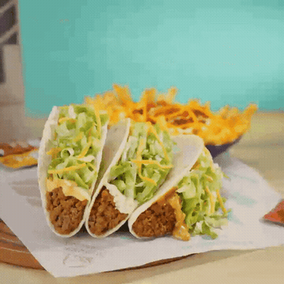 Three Tacos Next To French Fries GIF