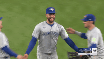 Three Toronto Blue Jays Players Hugging On Baseball Field GIF