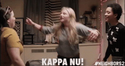 Three Women Are Dancing In A Room And One Of Them Is Saying Kappa Nu ! GIF