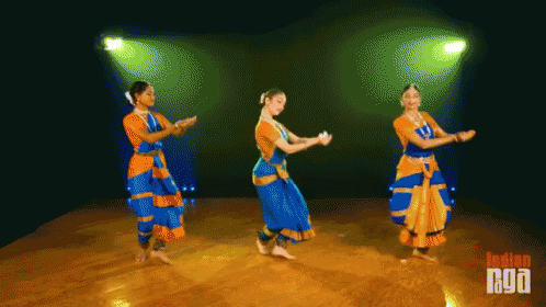 Three Women Are Dancing In Front Of A Green Light And The Words Indian Nyo On The Bottom GIF