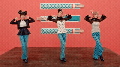 Three Women Are Dancing In Front Of A Pink Background GIF
