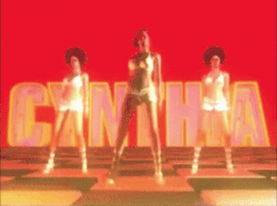 Three Women Are Dancing In Front Of A Sign That Says Cantha GIF