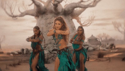 Three Women Are Dancing In Front Of A Tree GIF