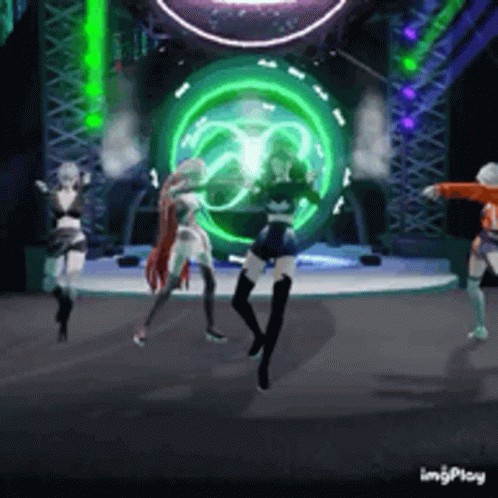 Three Women Are Dancing On A Stage In Front Of A Green Light GIF