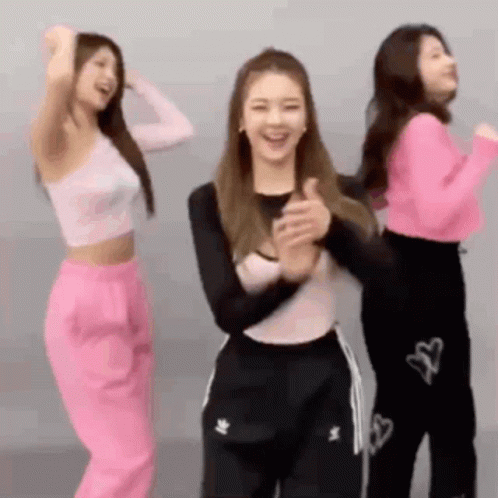 Three Women Are Dancing Together In A Room And One Of Them Is Clapping . GIF