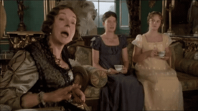 Three Women Are Sitting On A Couch One Is Holding A Cup And Saucer GIF