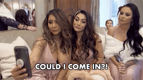 Three Women Are Sitting On A Couch Taking A Selfie With Their Cell Phones . GIF