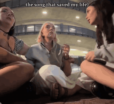 Three Women Are Sitting On The Ground With The Words The Song That Saved My Life Written Above Them GIF