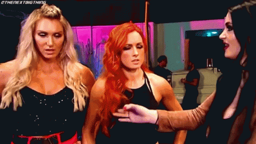 Three Women Are Standing Next To Each Other And One Of Them Is Wearing A Black Top GIF