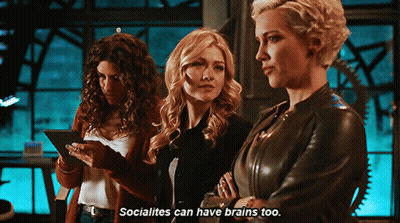 Three Women Are Standing Next To Each Other And One Of Them Says " Socialites Can Have Brains Too " . GIF