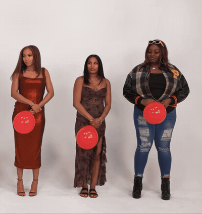 Three Women Are Standing Next To Each Other Holding Red Balloons With The Letter P On Them GIF