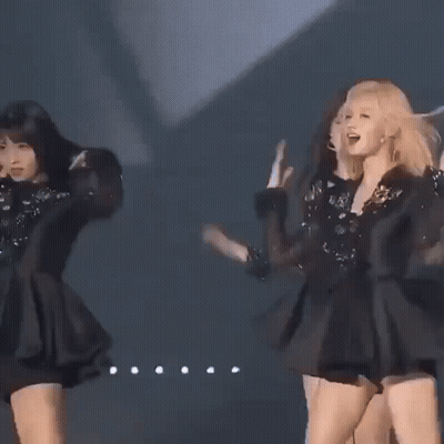 Three Women Are Standing Next To Each Other On A Stage In Black Dresses . GIF