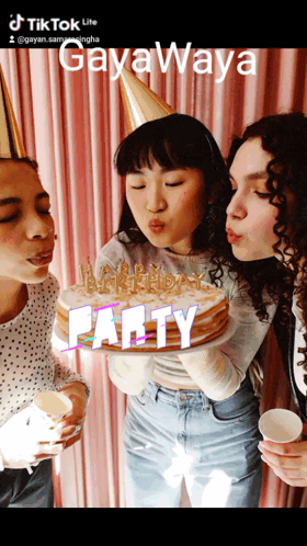 Three Women Blowing Out Candles On A Cake That Says Party On The Bottom GIF