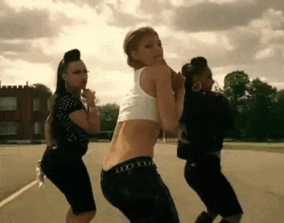 Three Women Dancing In Field With Castle GIF