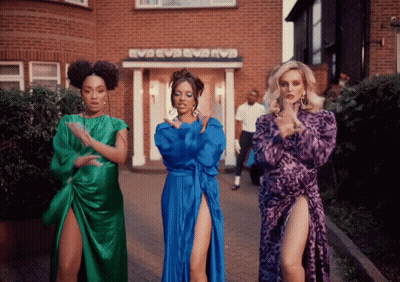 Three Women Dancing In Front Of EVB EVB EVB Building GIF