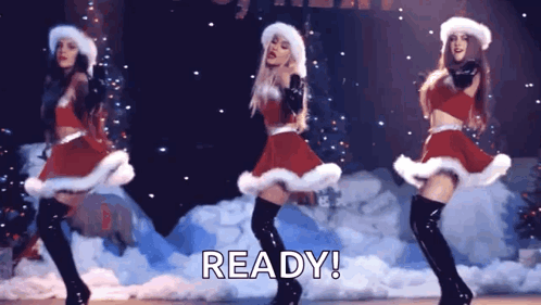 Three Women Dancing In Santa Costumes GIF