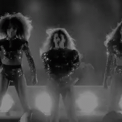 Three Women Dancing On Stage GIF