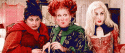 Three Women Dressed As Witches Standing In Living Room GIF