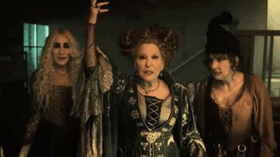 Three Women Dressed As Witches Standing Together GIF