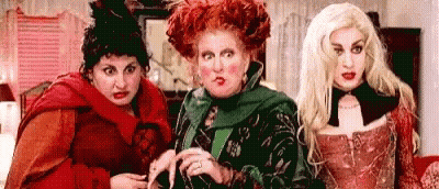 Three Women Dressed As Witches Standing Together GIF