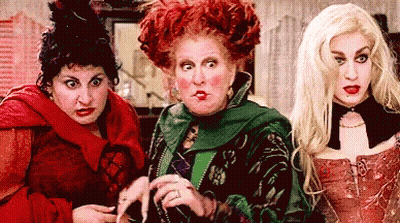 Three Women Dressed As Witches Standing Together GIF