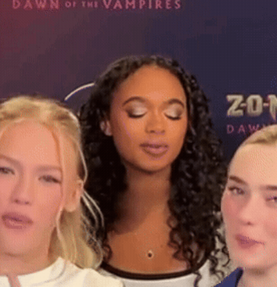 Three Women Eyes Closed In Front Of Dawn Of The Vampires Poster GIF