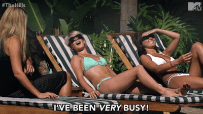 Three Women In Bikinis Lying On Lawn Chairs GIF
