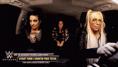 Three Women In Car With Sign Saying Go To WWENetwork.com GIF
