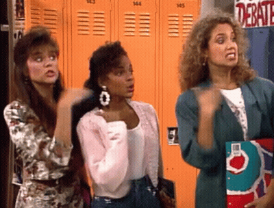 Three Women In Front Of Orange Lockers Saying Debate GIF