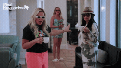 Three Women In Front Of Real Housewives Sign GIF
