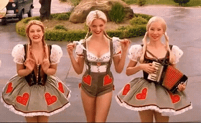 Three Women In German Costumes Standing Together GIF