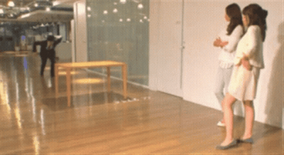 Three Women In Hallway With Man In Black Jacket GIF