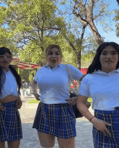 Three Women In School Uniforms Posing In Park GIF