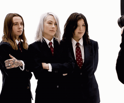 Three Women In Suits With Arms Crossed GIF