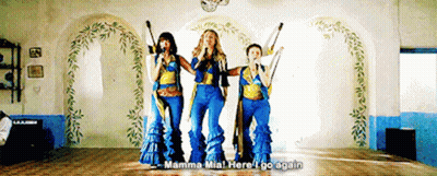 Three Women Singing In A Room With The Words Mamma Mia Here I Go Again Above Them GIF
