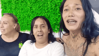 Three Women Sitting In Front Of Green Wall GIF