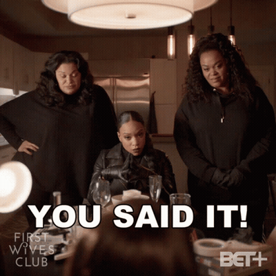 Three Women Standing Around A Table With The Words You Said It GIF