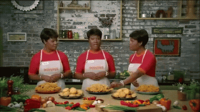 Three Women Wearing Aprons That Say Poivre Are Standing In A Kitchen GIF
