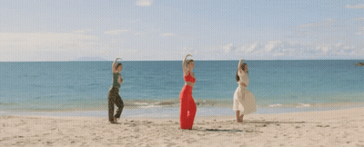 Three Women With Arms Outstretched On Beach GIF