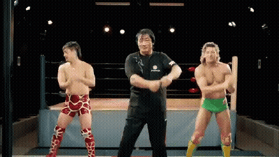 Three Wrestlers Dancing In Wrestling Ring Referee Watching GIF
