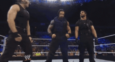Three Wrestlers In A Wrestling Ring With A W Logo GIF