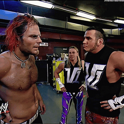 Three Wrestlers Standing Together One Wearing WWE Shirt GIF