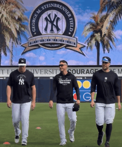 Three Yankees Baseball Players Are Walking In Front Of A George M. Steinbrenner Field Sign GIF