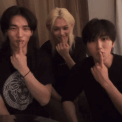 Three Young Men Are Posing For A Picture And One Of Them Is Holding His Finger To His Mouth GIF