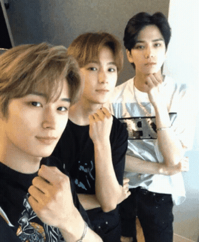 Three Young Men Are Posing For A Picture With One Wearing A Shirt That Says ' R.i.p. ' GIF