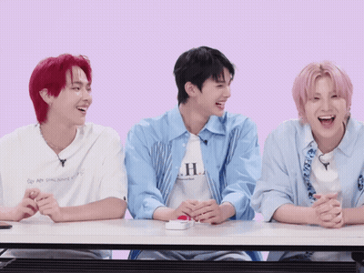 Three Young Men At Table One Wearing HL Shirt GIF