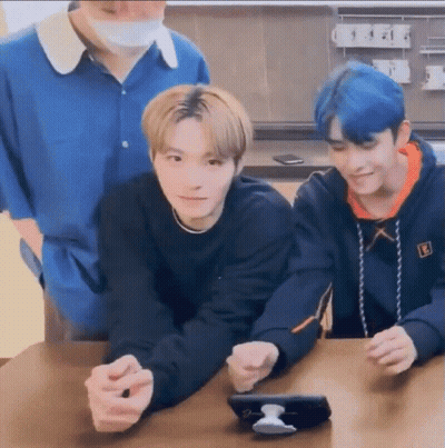Three Young Men Looking At A Phone GIF